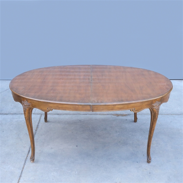 Appraisal: Carved wood dining table with two leaves by Baker Furniture