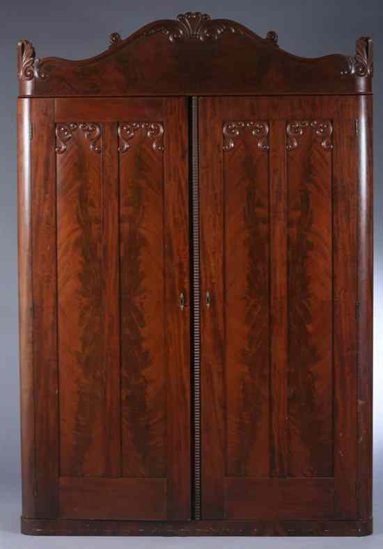 Appraisal: AMERCIAN FLAME MAHOGANY TWO-DOOR ARMOIRE mid th century Domed crest