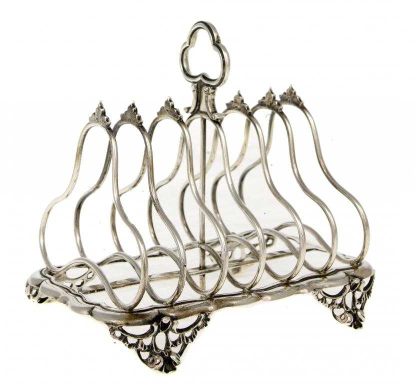 Appraisal: A VICTORIAN TOAST RACK with trefoil handle on openwork feet