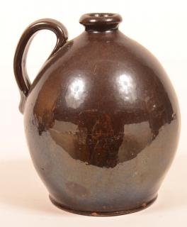 Appraisal: th Century Manganese Glazed Redware Pottery Ovoid Jug Molded spout