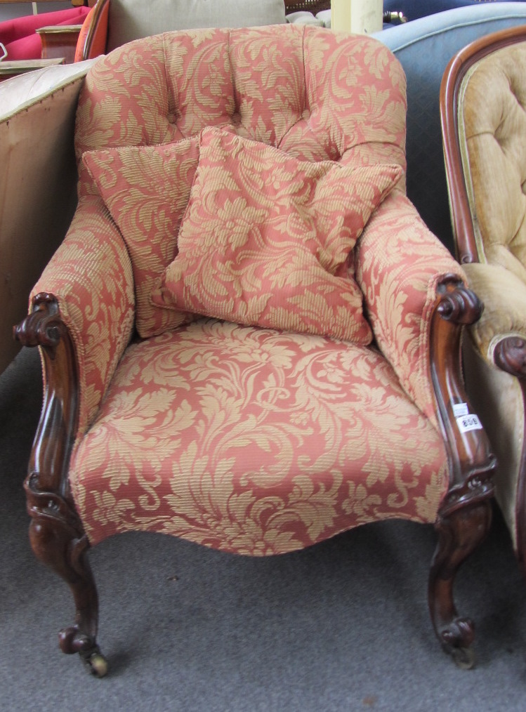 Appraisal: A th century rosewood framed button back armchair with serpentine