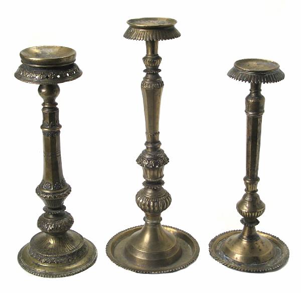 Appraisal: A group of three Tibetan bronze candlestands height of tallest