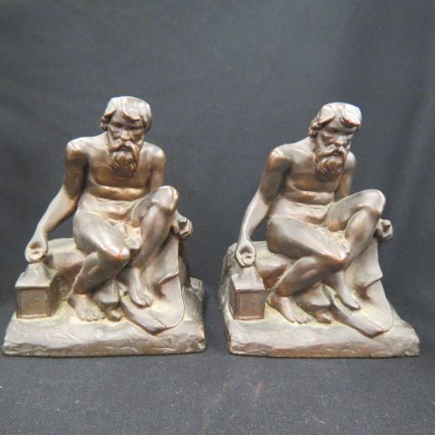 Appraisal: Pair of Figural Bronze Bookends seated man with lantern deco