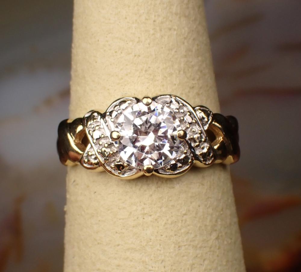 Appraisal: CUBIC ZIRCONIA AND TWO-TONE GOLD SOLITAIRE RING The k yellow