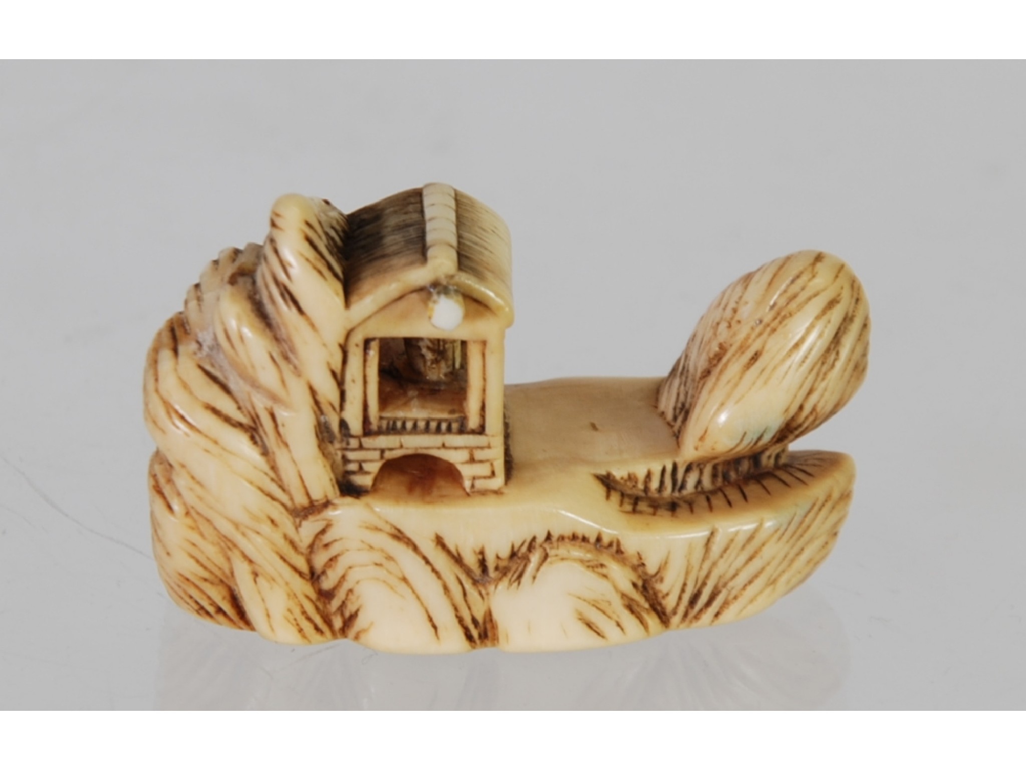 Appraisal: AN ORIENTAL CARVED IVORY NETSUKE in the form of a