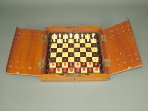 Appraisal: A mahogany cased travelling chess set with brass fittings and