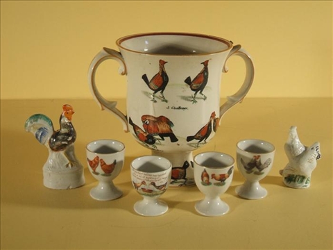 Appraisal: STAFFORDSHIRE CERAMIC LOVING CUP FOUR GERMAN PORCELAIN EGG CUPS WITH