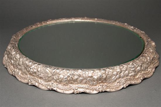 Appraisal: American repousse silver and mirrored glass round plateau Jacobi Jenkins