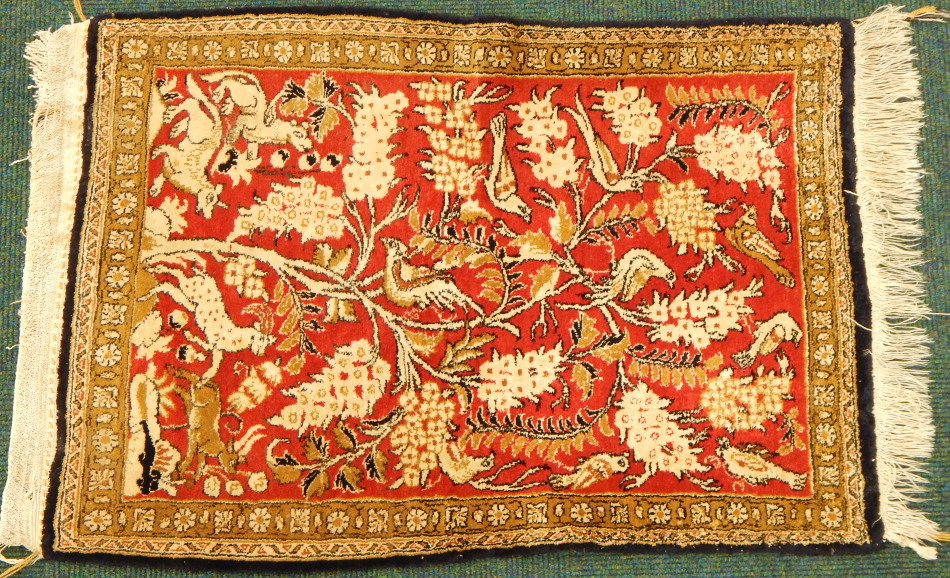 Appraisal: A thC Eastern prayer rug in floral and animal pattern