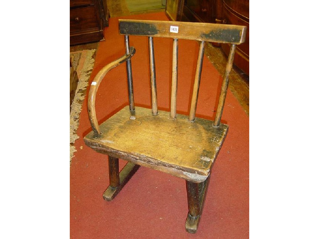 Appraisal: An th century primitive stick back low rocking chair in