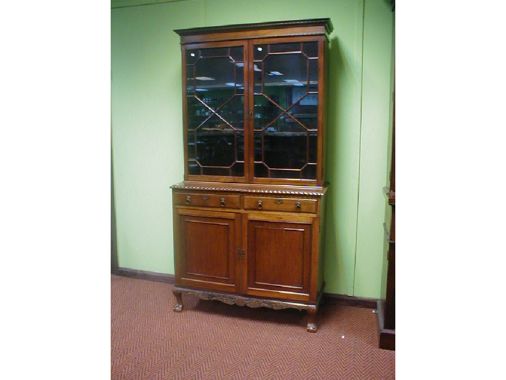 Appraisal: An Edwardian walnut cabinet bookcase with moulded cornice over two