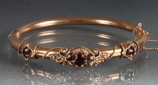 Appraisal: Victorian K yellow gold garnet and seed pearl bangle bracelet