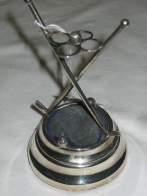 Appraisal: A TIE PIN STAND modelled as a pierced quatrefoil with