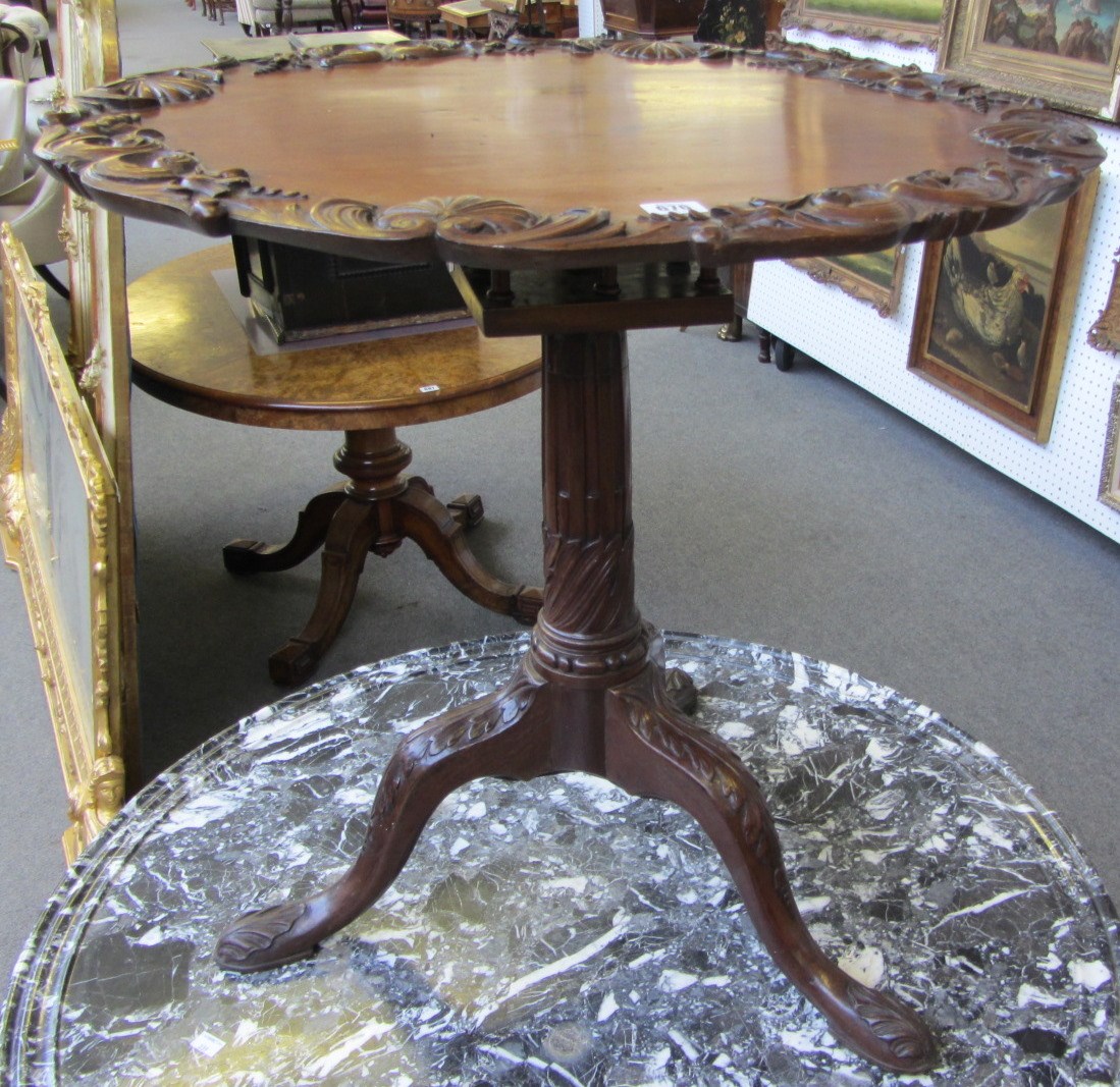 Appraisal: A th century style mahogany occasional table the carved circular