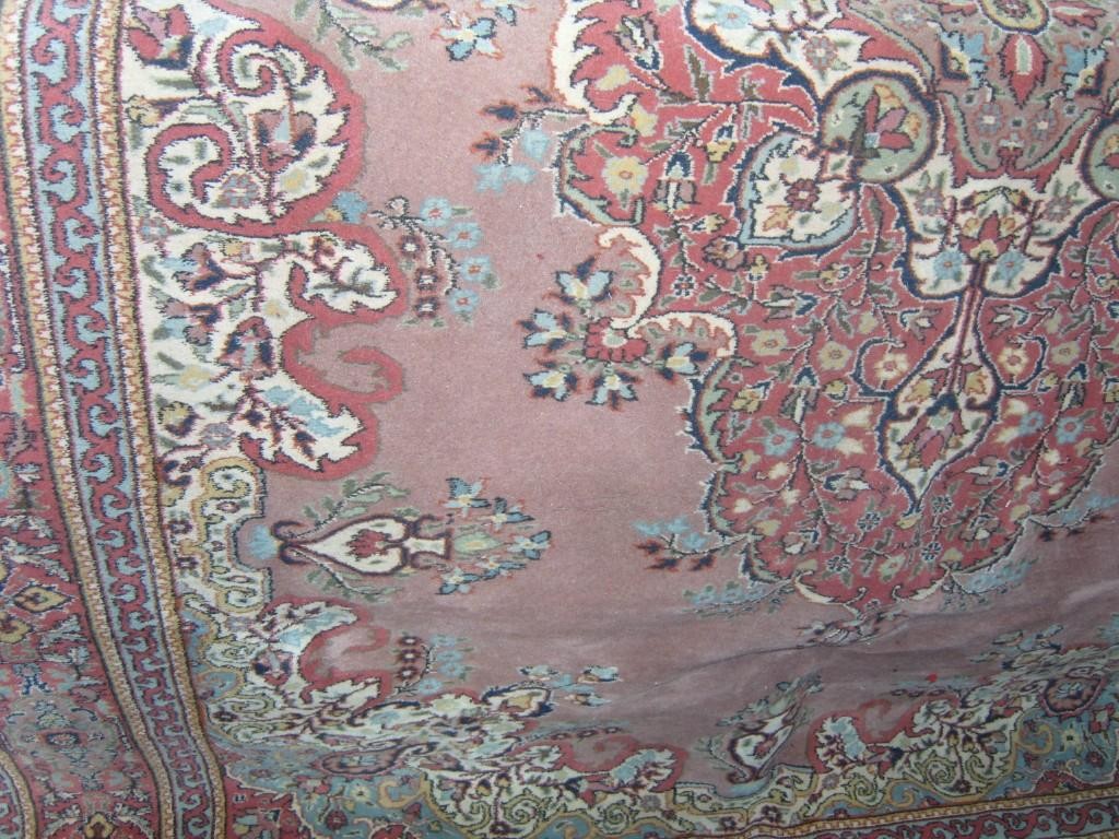 Appraisal: Large pink ground rug in the Persian style with floral