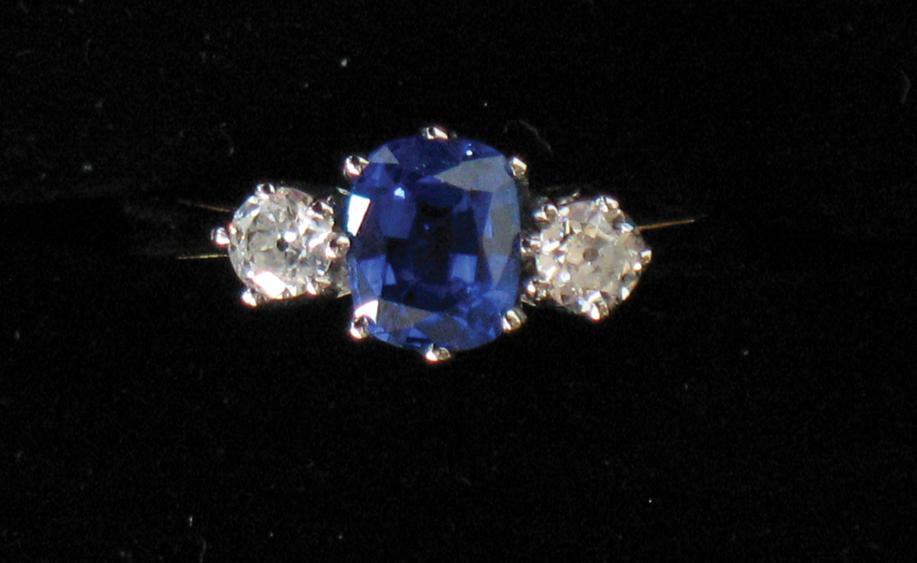 Appraisal: A SAPPHIRE AND DIAMOND DRESS RING the central oval cushion-cut