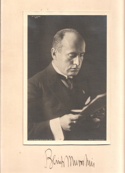 Appraisal: MUSSOLINI BENITO Photograph Signed image in a suit reading papers