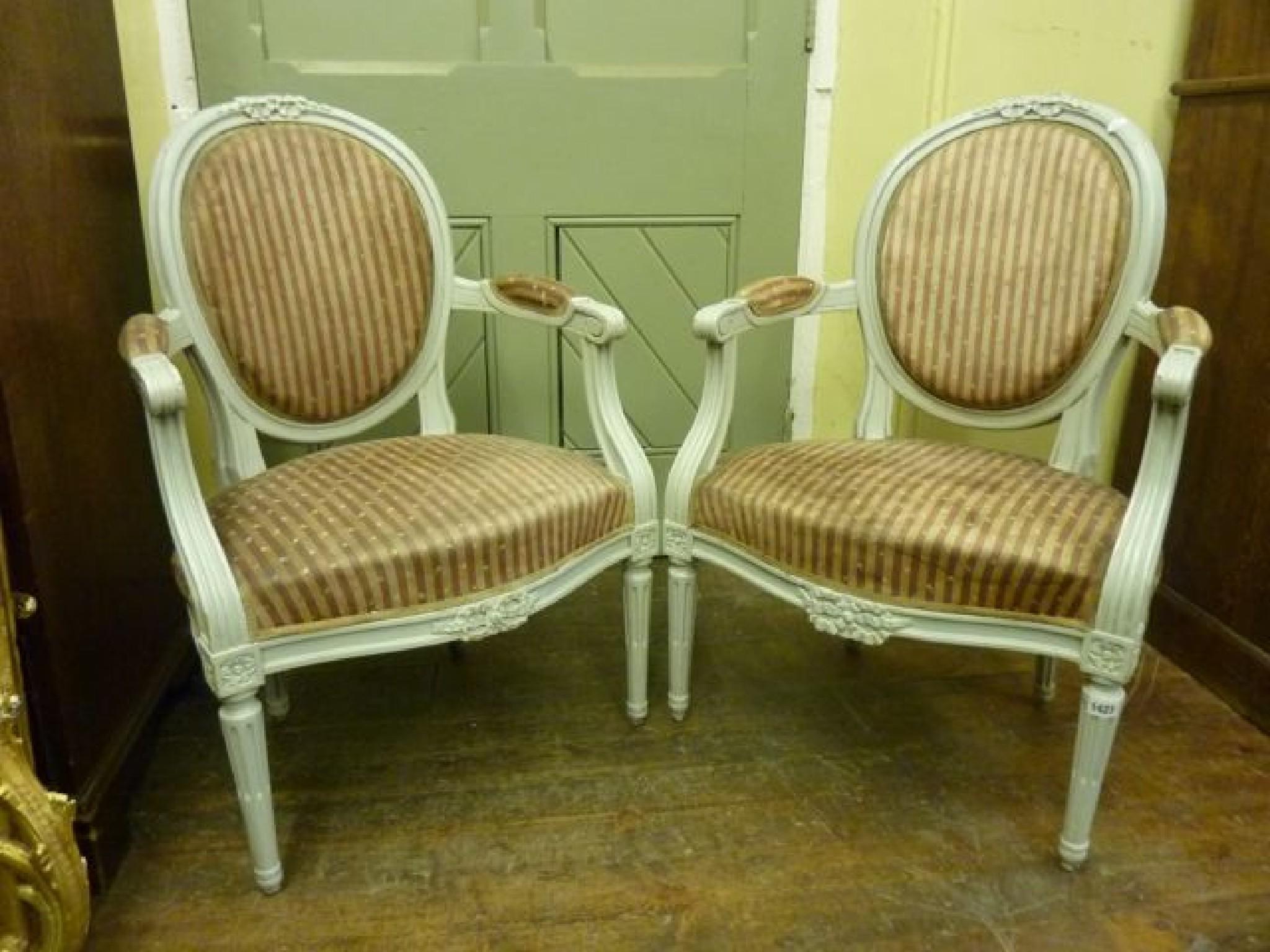 Appraisal: A pair of French style open armchairs with striped upholstered