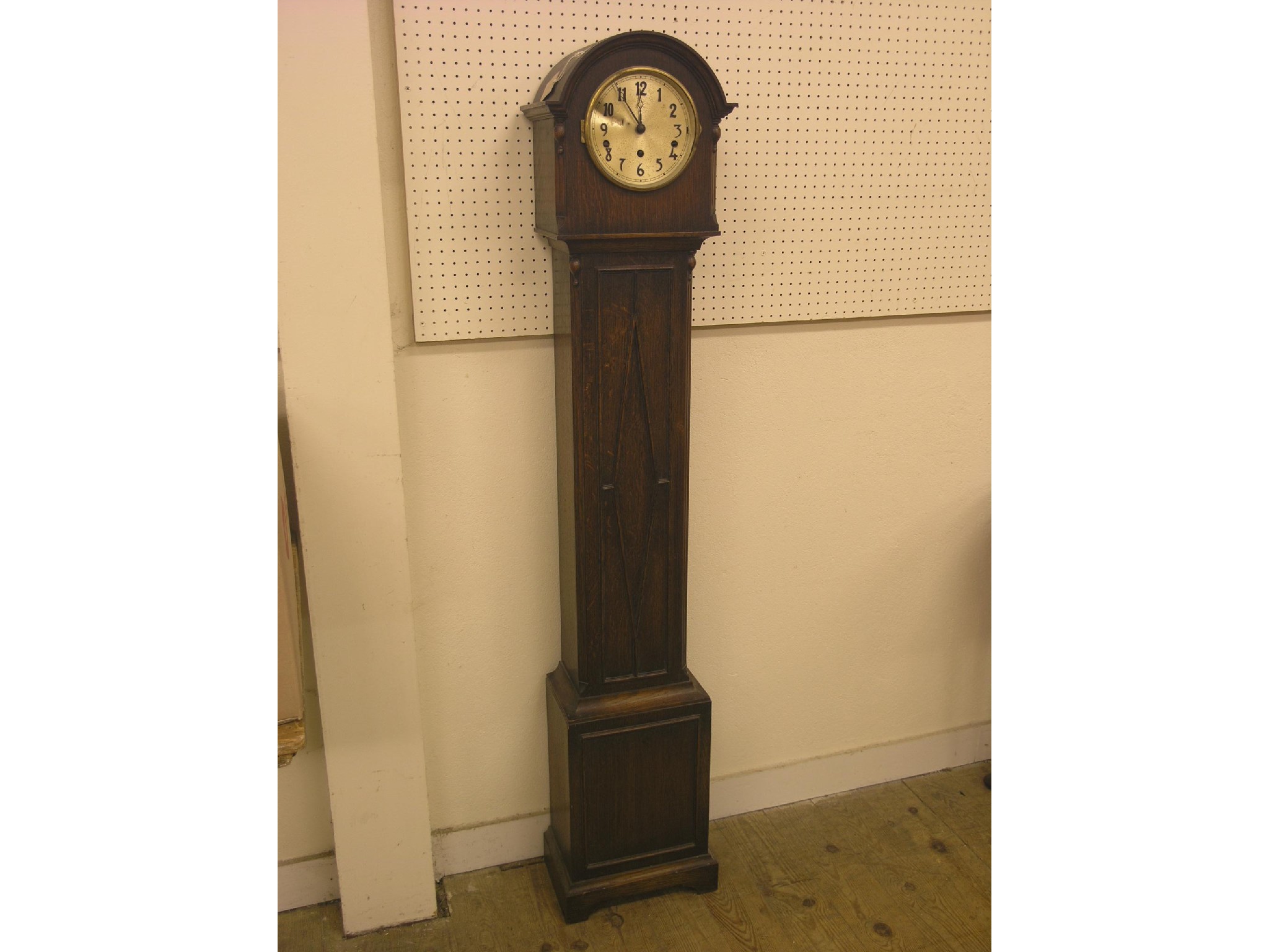 Appraisal: A dark oak grandmother clock chiming movement with pendulum ft