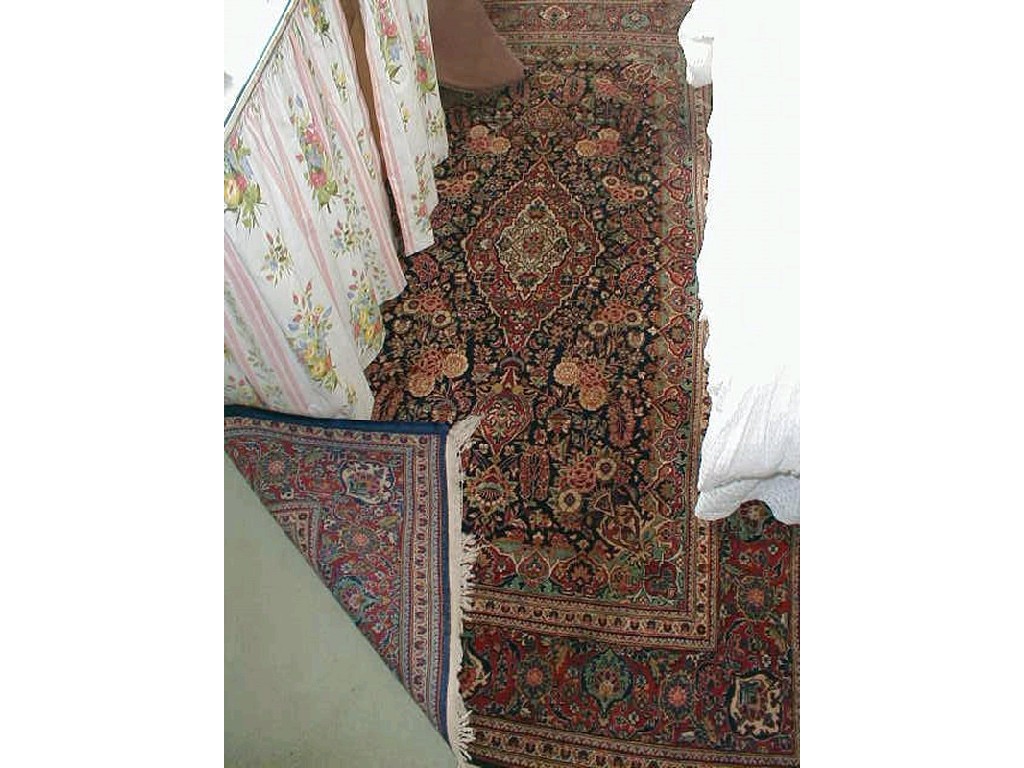 Appraisal: A Kashan rug with floral central field on a dark