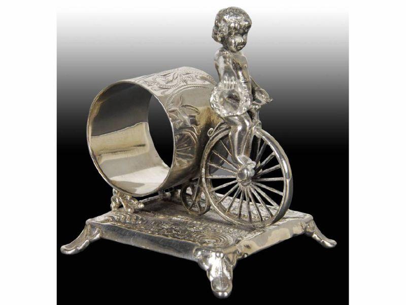 Appraisal: Draped Cherub Riding Bicycle Figural Napkin Ring Description Footed square