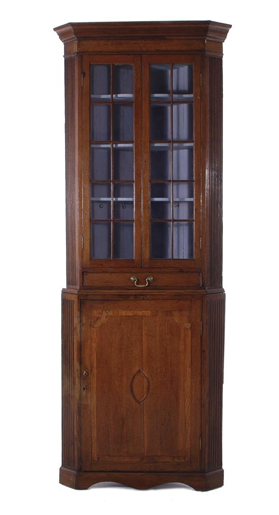 Appraisal: English oak corner cupboard circa canted crown glazed doors over