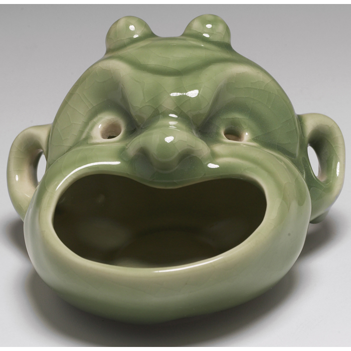 Appraisal: Rookwood vase grotesque head covered in a light green glaze