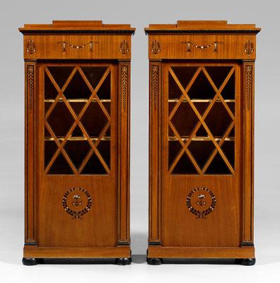 Appraisal: Pair Biedermeier style bookcase cabinets each with ebonized and mother-of-pearl