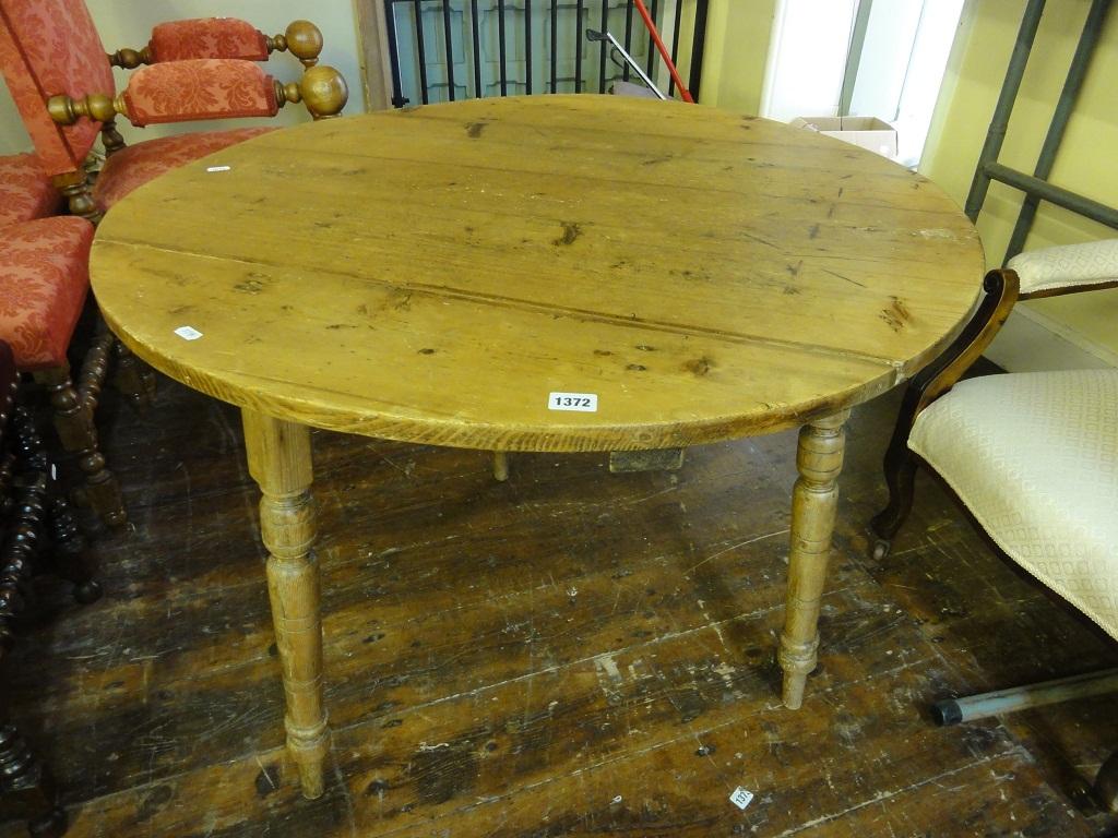 Appraisal: An antique stripped pine cricket table the circular boarded top