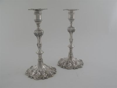 Appraisal: A pair of early George III cast candlesticks on shaped