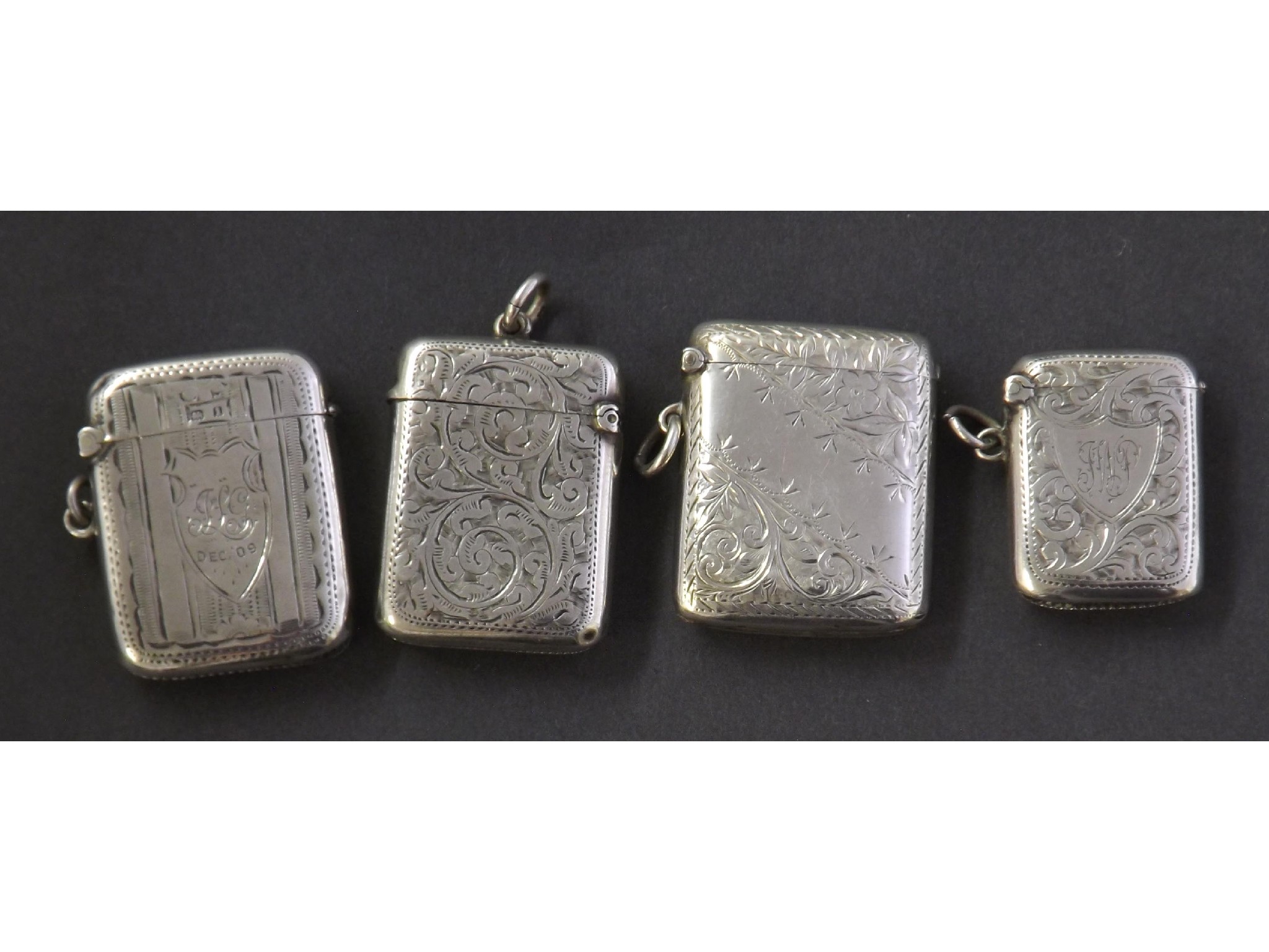 Appraisal: Four silver vesta cases each engraved with floral decoration oz