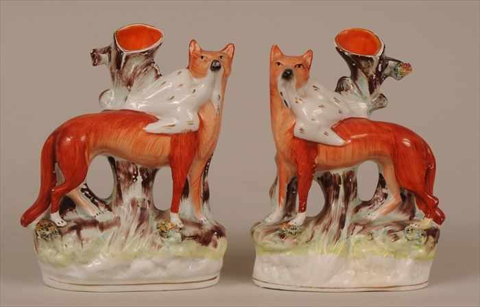 Appraisal: PAIR OF STAFFORDSHIRE SPILL VASES Each modeled with fox grasping