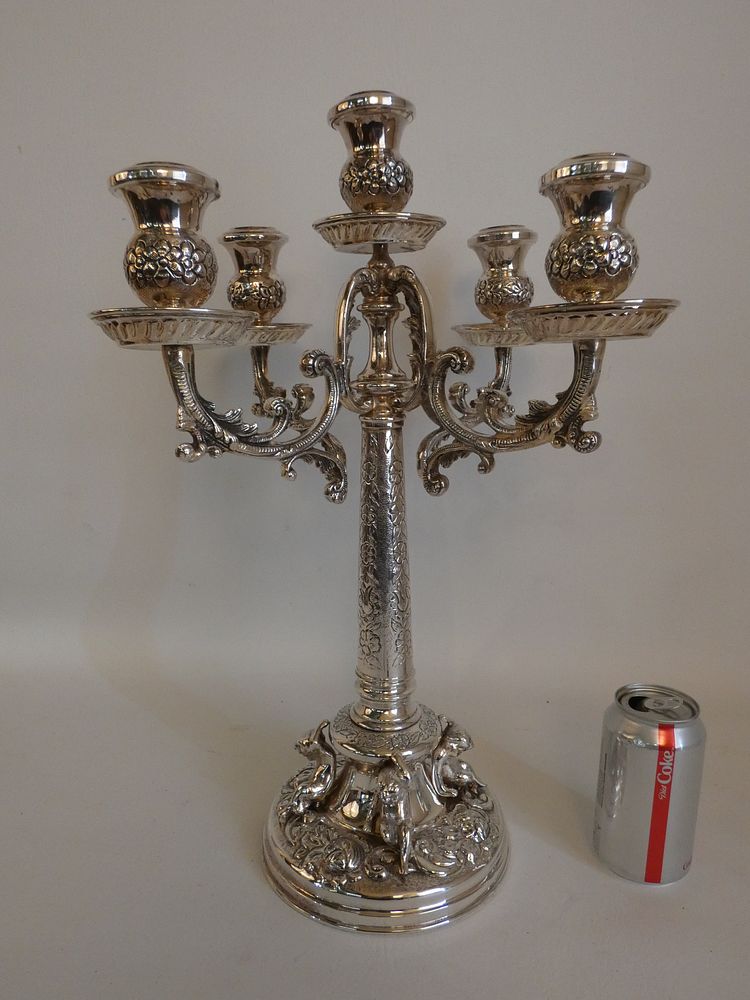 Appraisal: SILVER CANDELABRA WITH CHERUBS Large solid silver arm rococo design