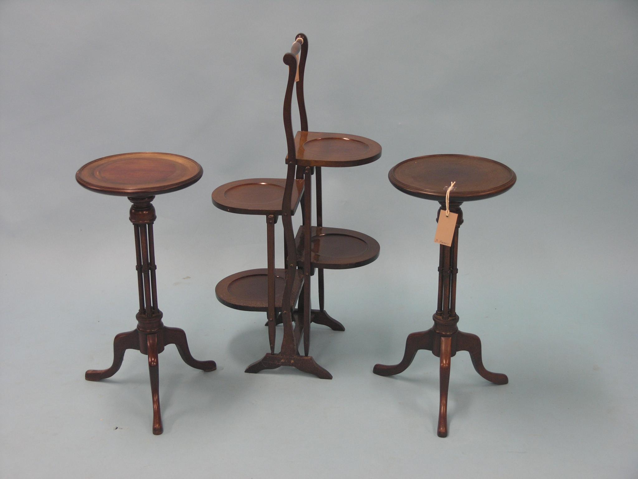 Appraisal: A pair of mahogany wine tables circular tops on cluster-column