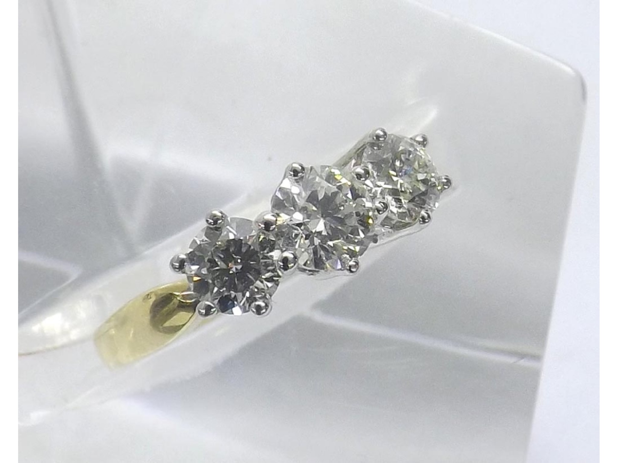 Appraisal: - -a ct gold three stone round brilliant-cut diamond ring