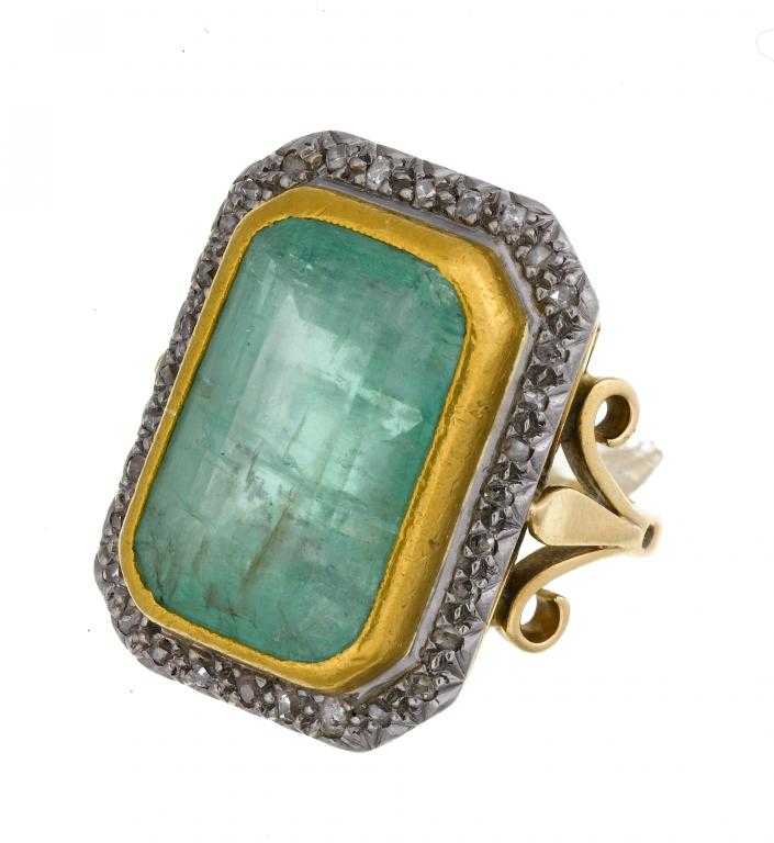 Appraisal: AN EMERALD AND DIAMOND CLUSTER RING the step cut emerald