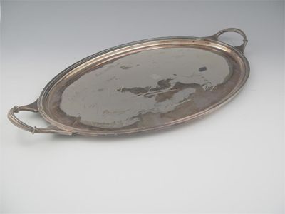 Appraisal: A modern two-handled oval tray with a reeded border central