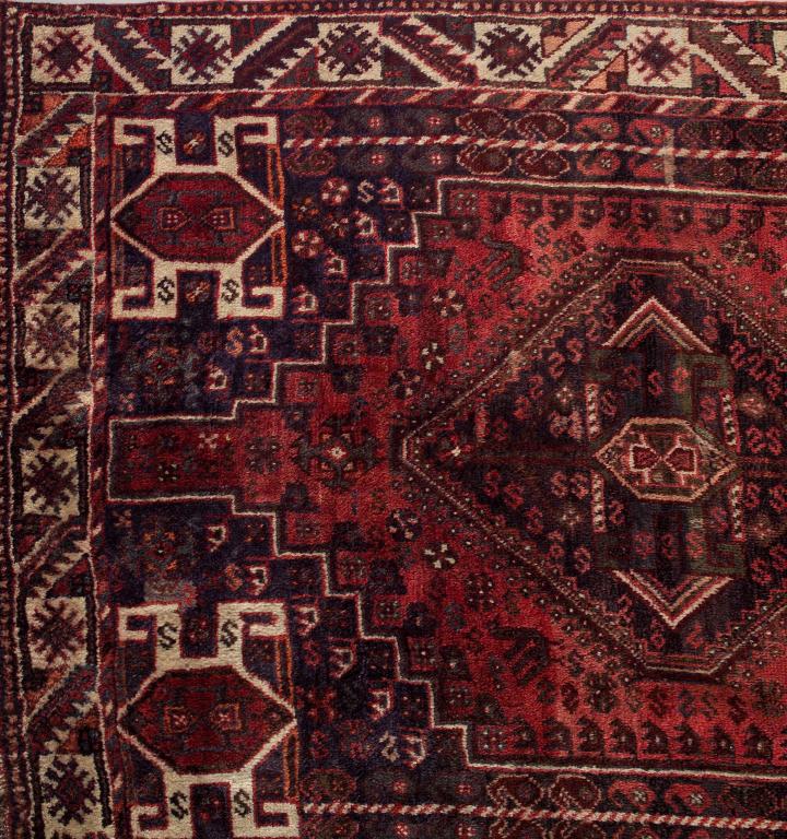 Appraisal: BIJAR RUG central field with a dark pink ground within