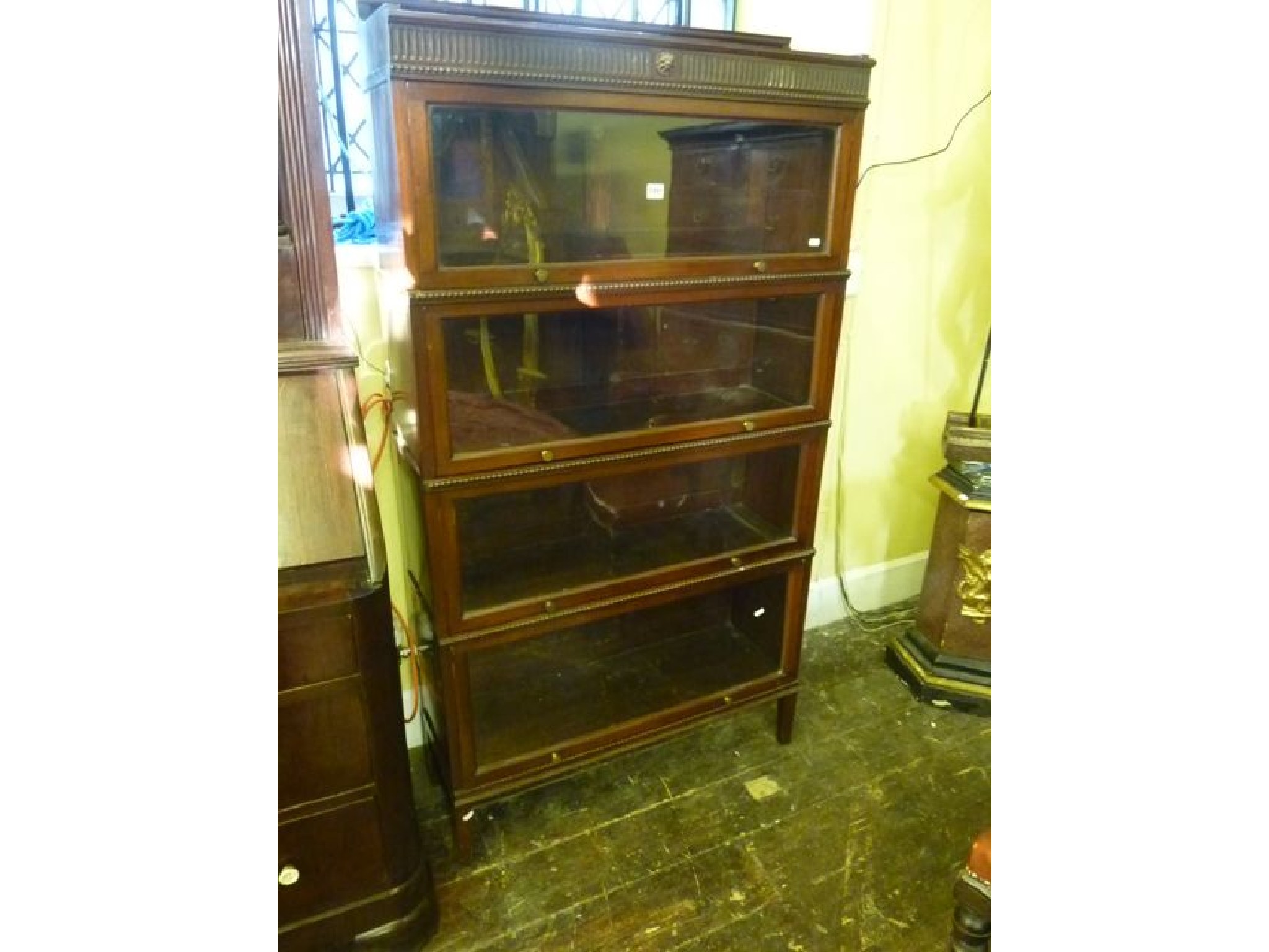 Appraisal: An Edwardian mahogany -tier sectional bookcase with glazed up-and-over doors