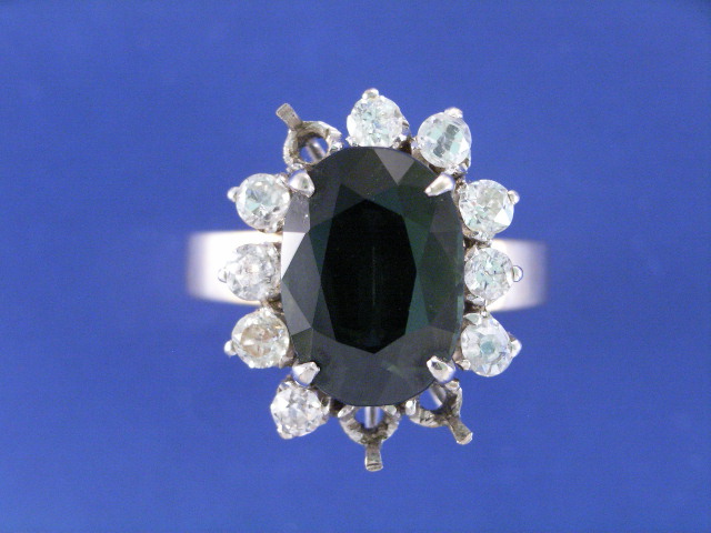 Appraisal: A ct gold green sapphire and nine diamond cluster ring