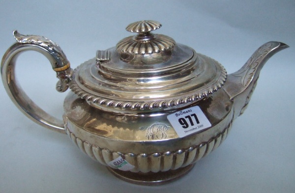 Appraisal: A silver teapot with fluted decoration a gadrooned rim and