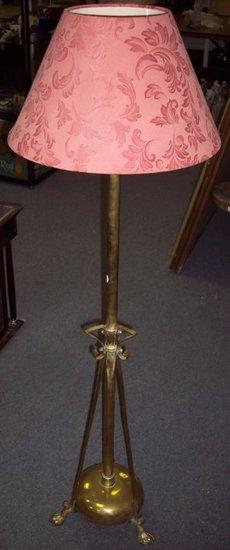 Appraisal: A brass adjustable standard lamp on circular base with lion