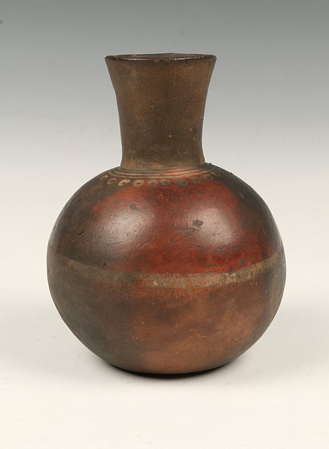 Appraisal: A SPOUTED JAR with reddish brown body blackened by kiln