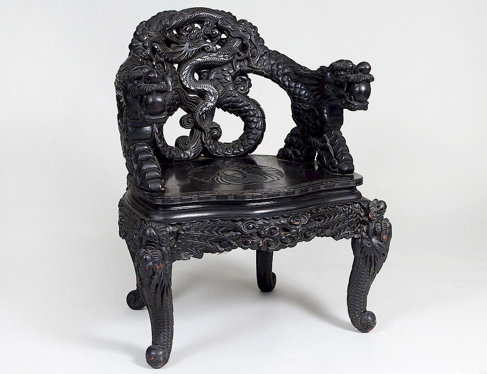 Appraisal: CHINESE CARVED EBONIZED WOOD DRAGON ARMCHAIR Circa The curved dragon