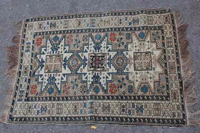 Appraisal: A CAUCASIAN WHITE GROUND RUG decorated an interlocking geometric pattern