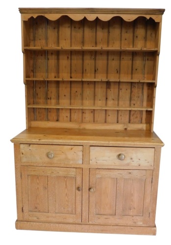 Appraisal: A pine kitchen dresser the upper section with three shelves