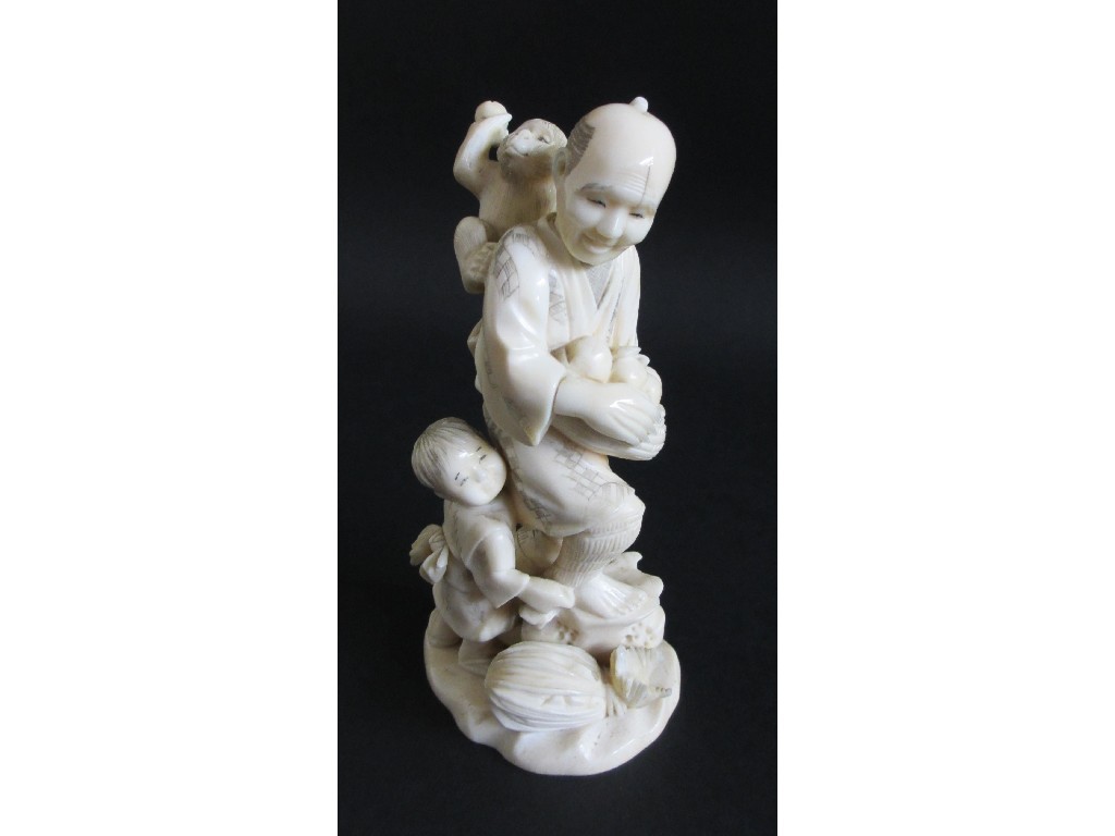 Appraisal: A Japanese carved ivory figure of a man gathering fruit