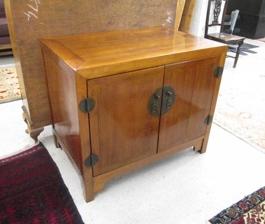 Appraisal: CHINESE ELMWOOD STORAGE CABINET the two doors opening to interior