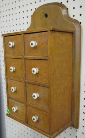 Appraisal: Antique oak hanging spice cabinet '' tall drawers porcelain pulls