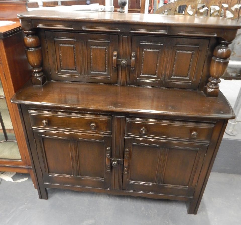 Appraisal: An Ercol type oak court cupboard the raised back with